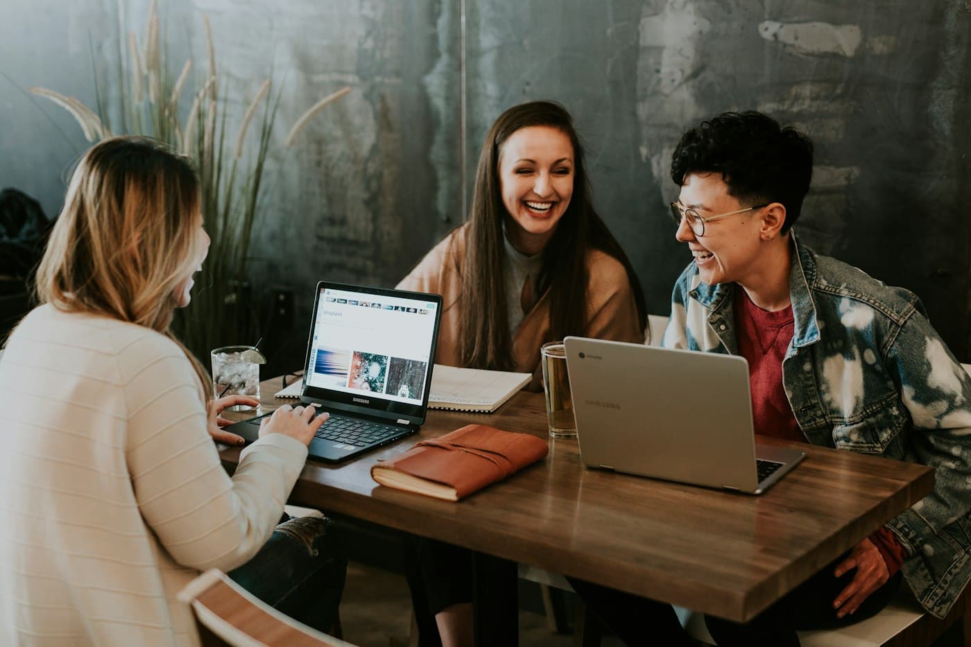 Group of people learning together around laptops