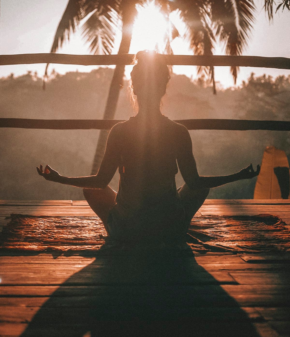 Person meditating in warm evening light